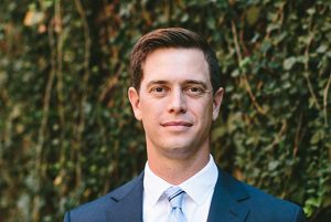 white man in blue suit outdoors