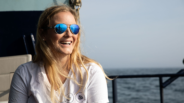 Woman in sunglasses smiles on boat