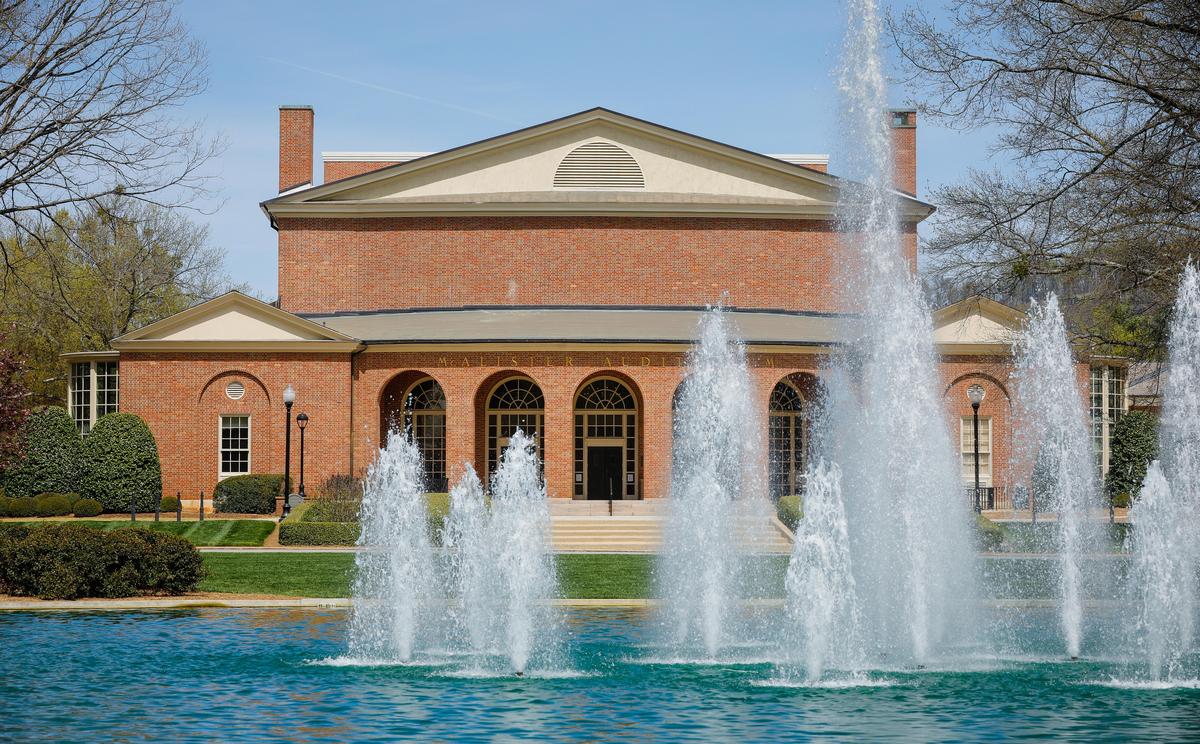 red brick building with fountains in foreground