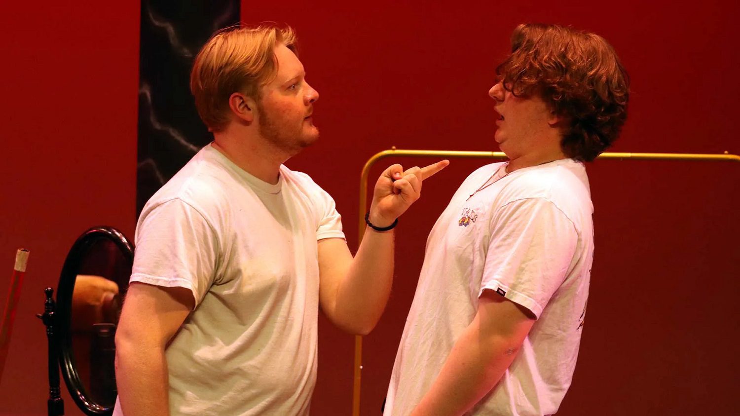 two white male actors perform on stage
