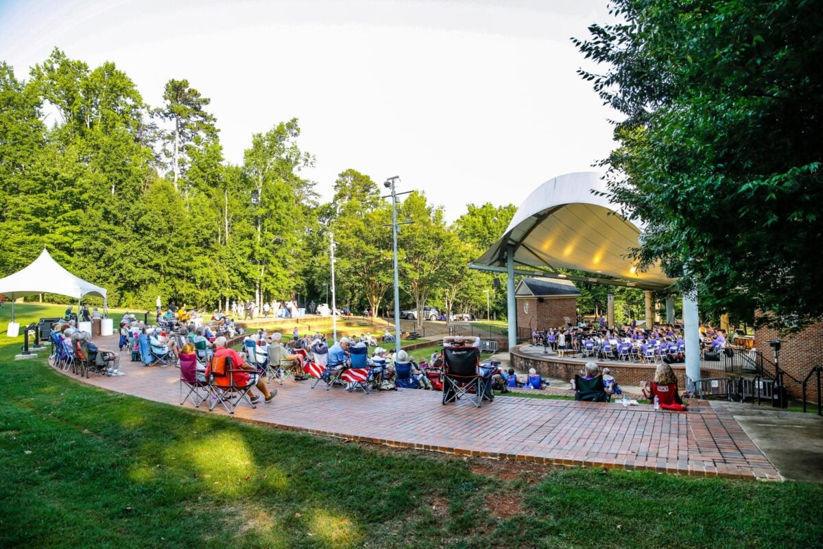An amphitheater with lots of people on a sunny afternoon.