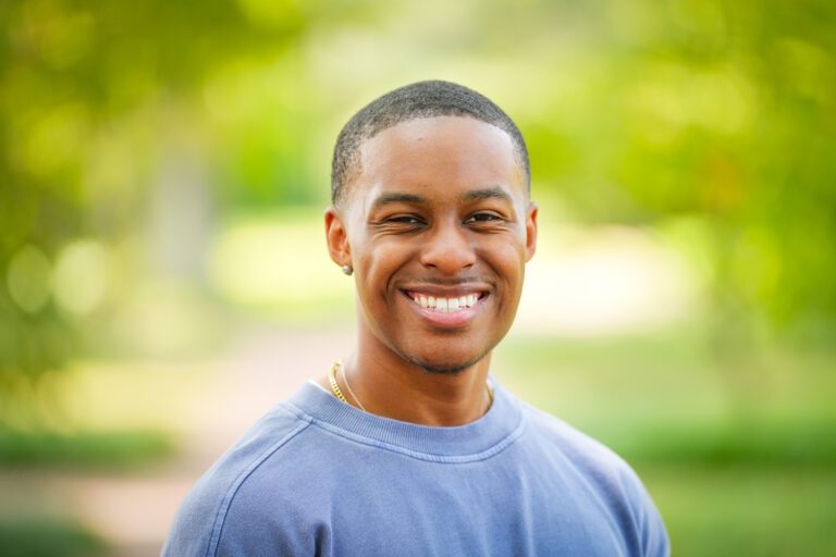 Portrait of Jalen Livingston on a path with trees blurred in the background.