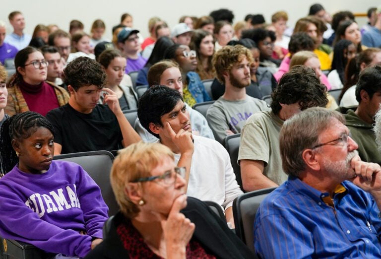Photo of a crowd sitting in an auditorium. 