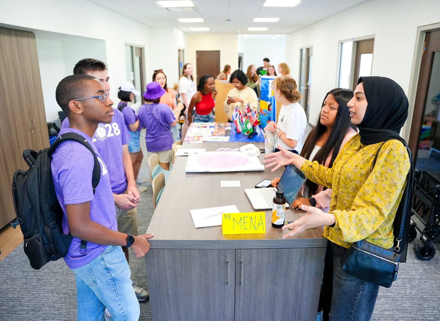 Members of FU MENA talk with freshmen during the Center for Interpersonal Connections grand opening celebration in Lakeview Hall on Monday, August 26, 2024. Photo by Nathan Gray, Furman University.