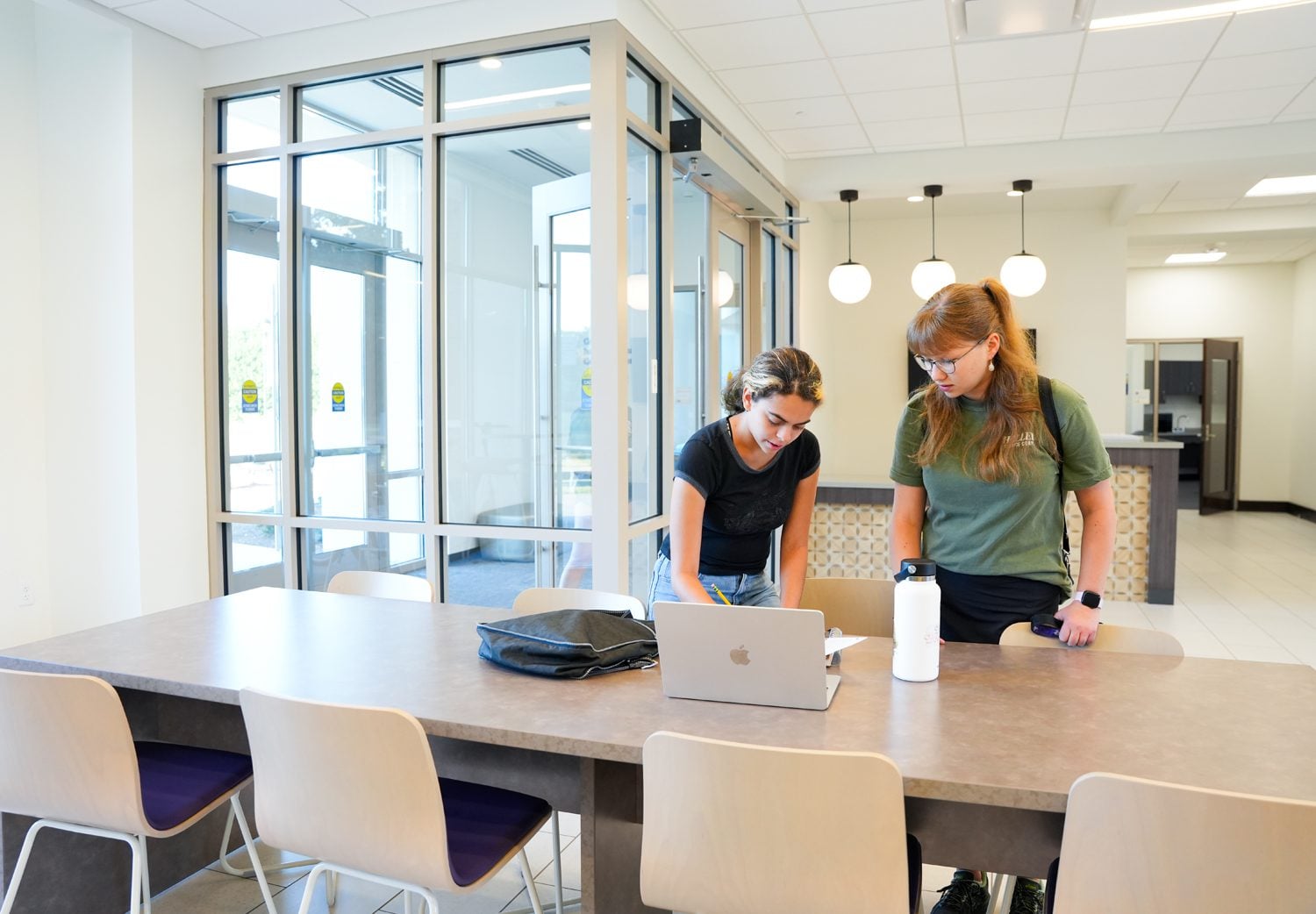 Anna Louise Panhorse ’28, right, helps Isabel Balsa ’28 with homework in the bottom floor of Lakeview Hall on Thursday evening, September 5, 2024. Photo by Nathan Gray, Furman University.