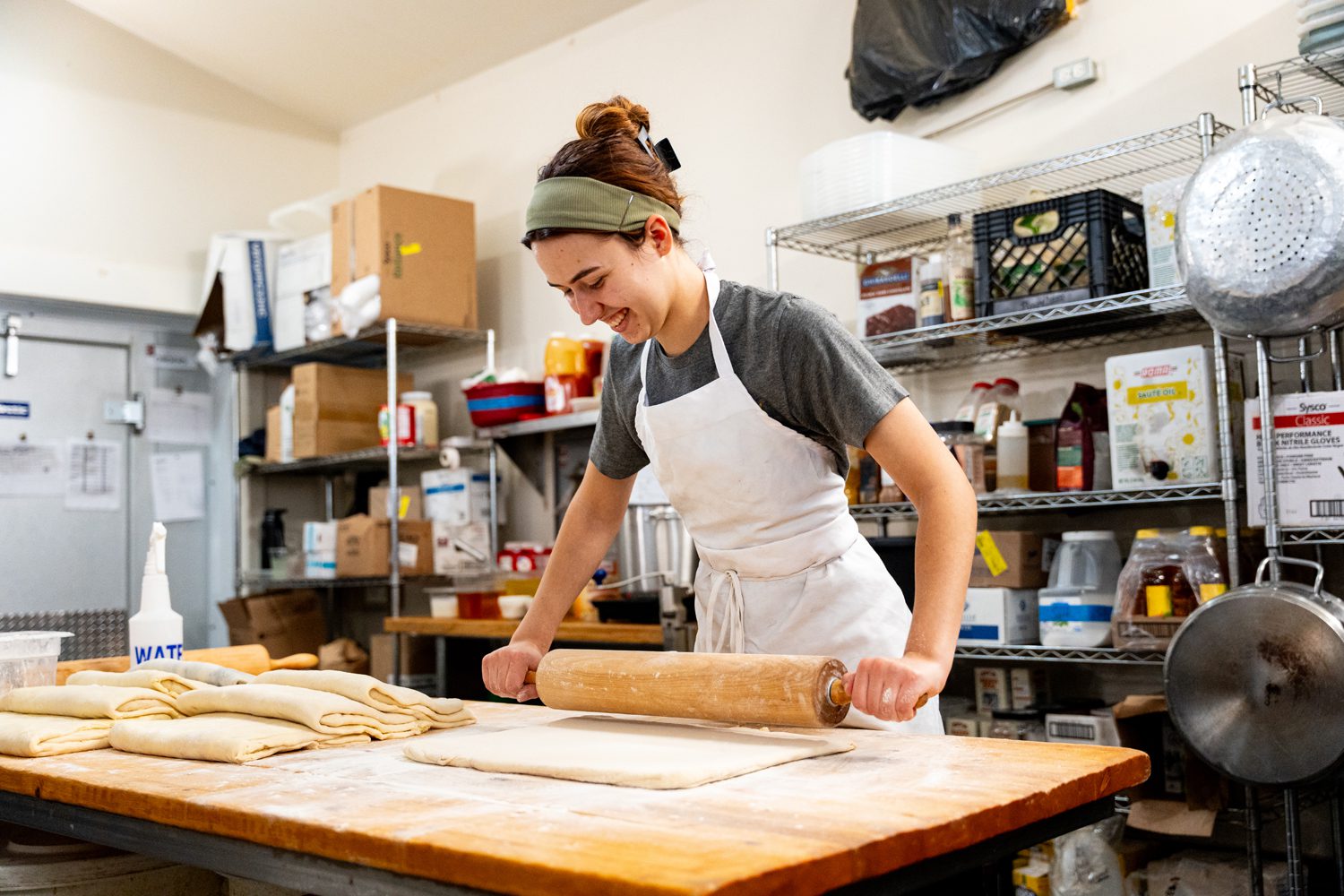 An employee of Upcountry Provisions in Travelers Rest, SC rolls dough in their kitchen. Photo by Owen Withycombe.