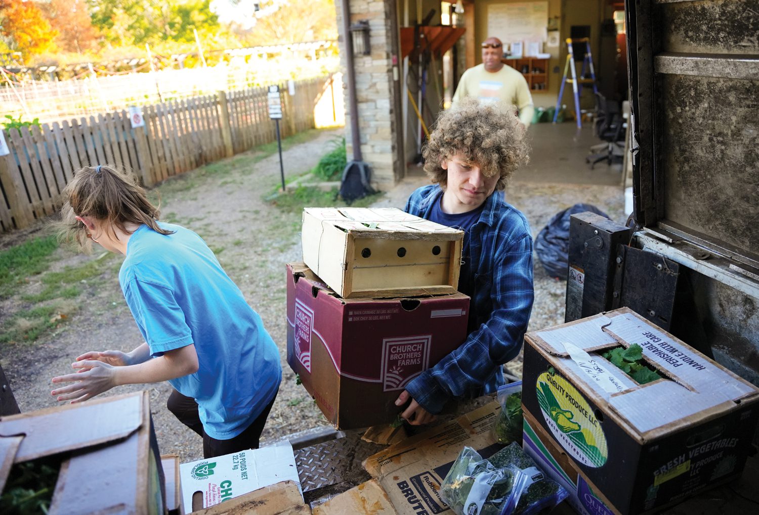 Emillie Milburn ’26, Kevin Amon ’26 and Bruce Adams, manager of the Furman Farm, load a truck with vegetables that were harvested at the farm to be taken to the dining hall on November 15, 2024. Photo by Nathan Gray