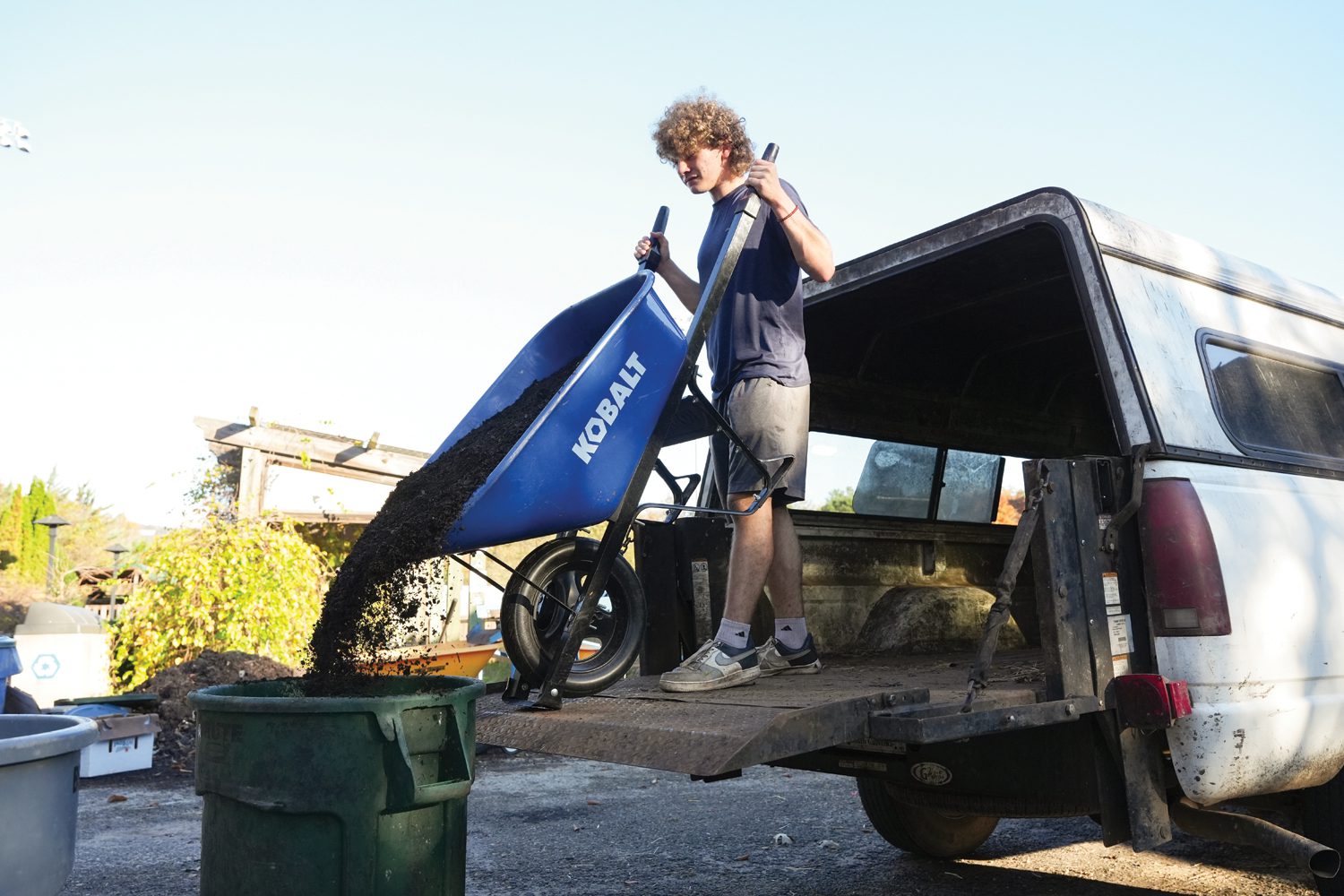 Kevin Amon ’26 pours composted soil into a plastic container at the Furman Farm on November 11, 2024. The compost was made using food waste from the Dining Hall. Photo by Nathan Gray