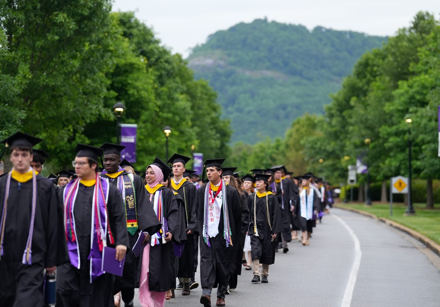 Class of 2025 graduates walk out of McAlister Auditorium to Paladin Stadium at the start of the commencement ceremony on May 10.