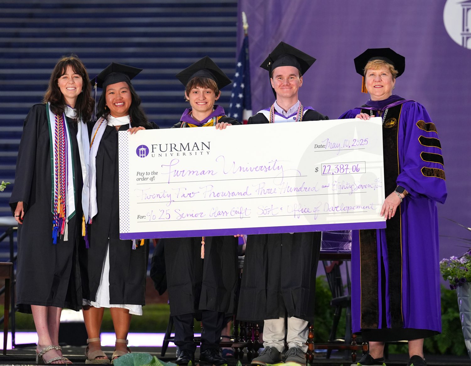 Members of the senior class present the Senior Class Gift to President Elizabeth Davis during the 2025 Commencement Ceremony in Paladin Stadium on May 10.