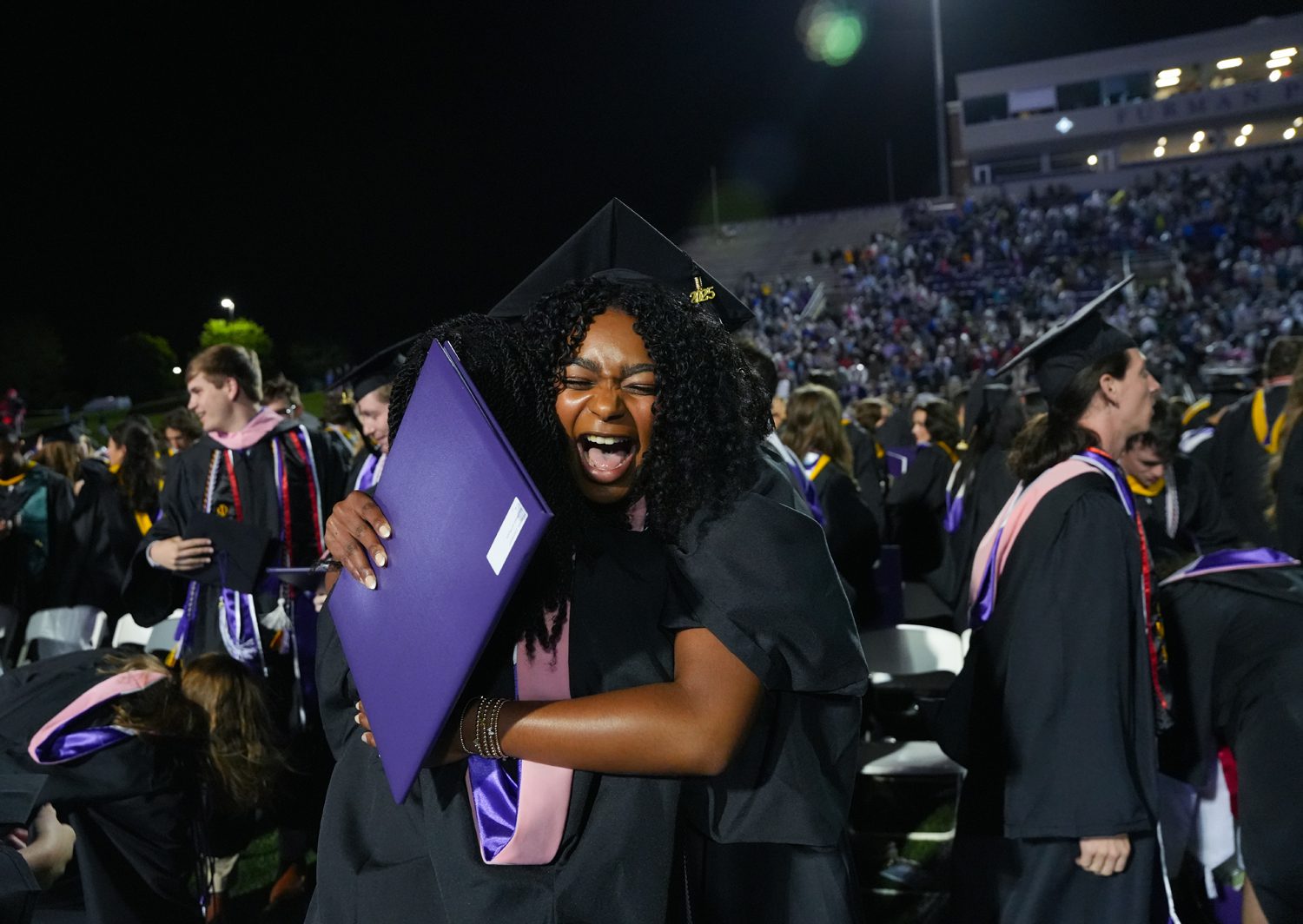 Graduates celebrate together after the 2025 Commencement Ceremony in Paladin Stadium on May 10.