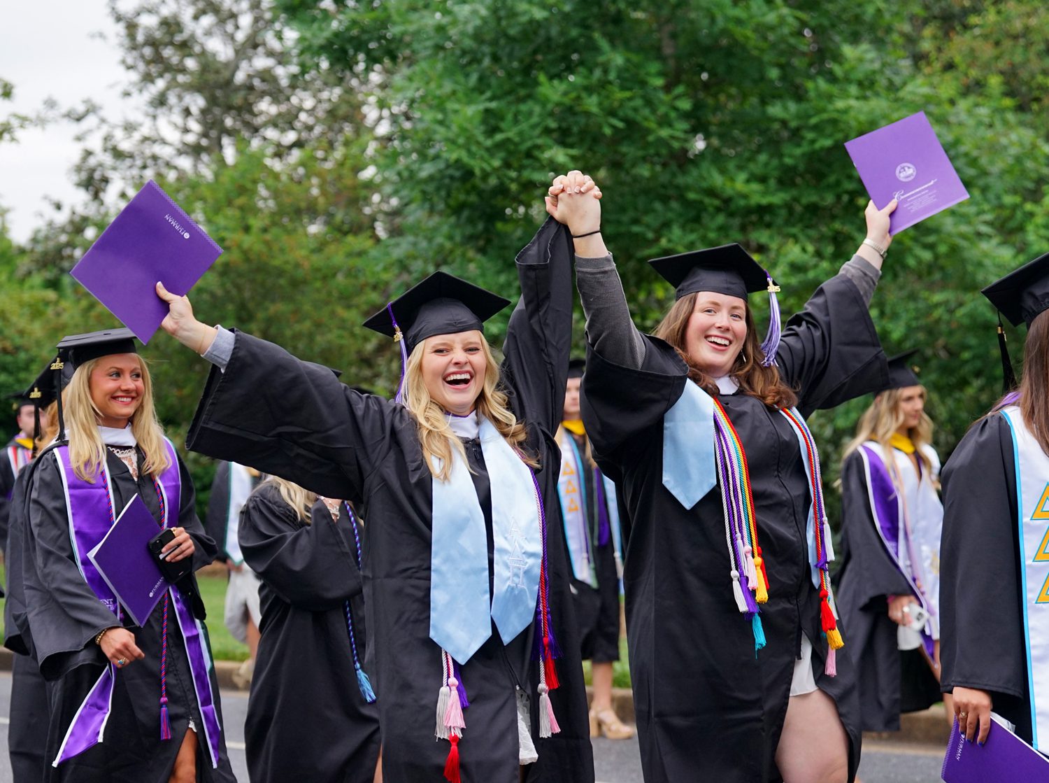 Students celebrate while walking from McAlister Auditorium to Paladin Stadium at the start of the commencement ceremony on May 10.