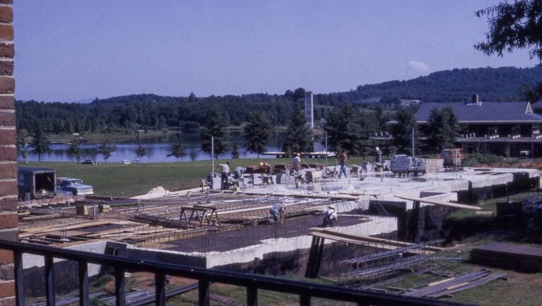 Construction crews work on the foundation of a building in a historical photo from the 1960s.