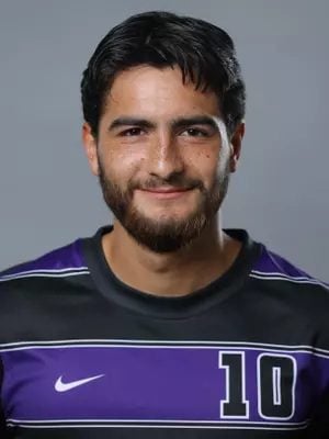 A headshot of a man in a soccer jersey