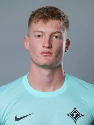 A headshot of a man in a soccer jersey