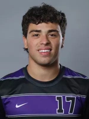 A headshot of a man in a soccer jersey