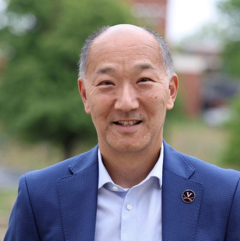 A portrait of an Asian man in a blue suit.