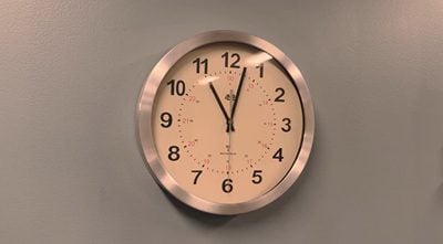 A wall clock on a neutral background.