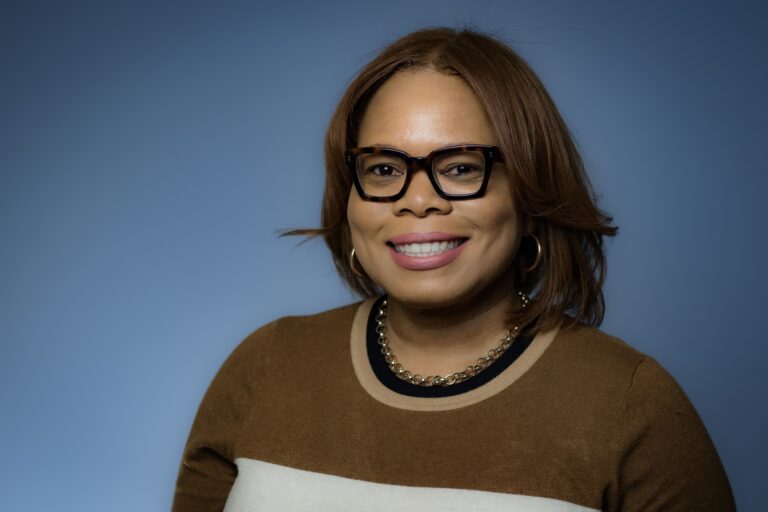 A portrait of a Black woman in a sweater.