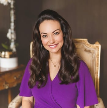 A white woman with long brown hair wears purple and sits in an ornate chair. Courtney Tollison