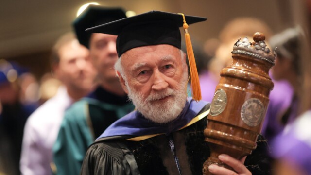 William Brantley, professor of physics, acts as macebearer during Opening Convocation.
