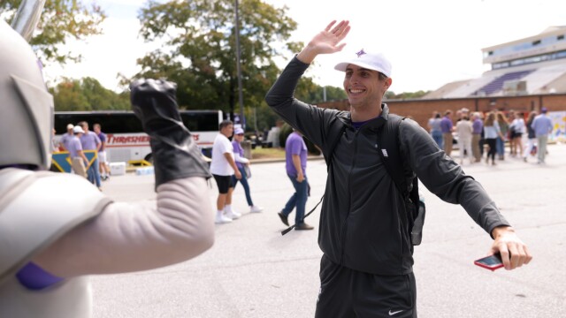 Luke Sommerdyke '24 high-fives Victor outside Paladin Stadium.
