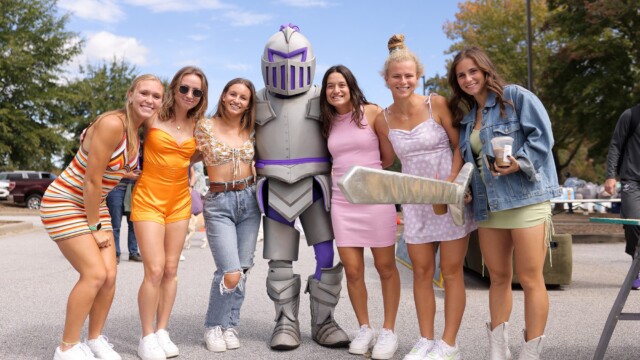 Members of the Furman Women's Lacrosse team pose with Victor outside Paladin Stadium.