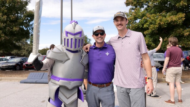 The Mangus family poses with Victor outside Paladin Stadium.