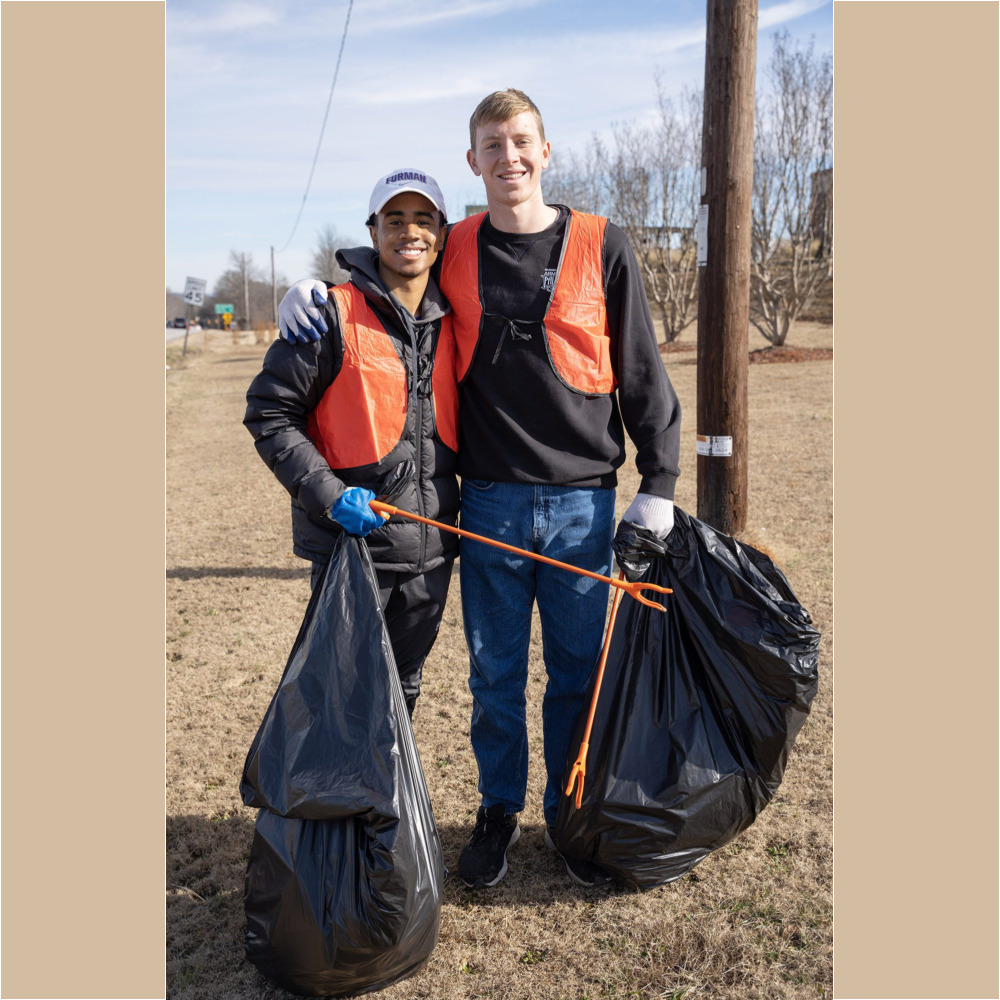 Furman men’s soccer player Christian Newman ’24, left, and Denison Jones ’24 pose for a photo while helping pick up trash along US Highway 25 in Travelers Rest as part of the MLK Day of Service on Monday, January 16, 2023.