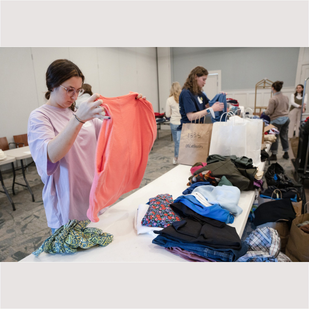 Lana Aga ’23 helps organize donated clothing at The Woodlands at Furman, an active senior living community, as part of the MLK Day of Service on Monday, January 16, 2023.