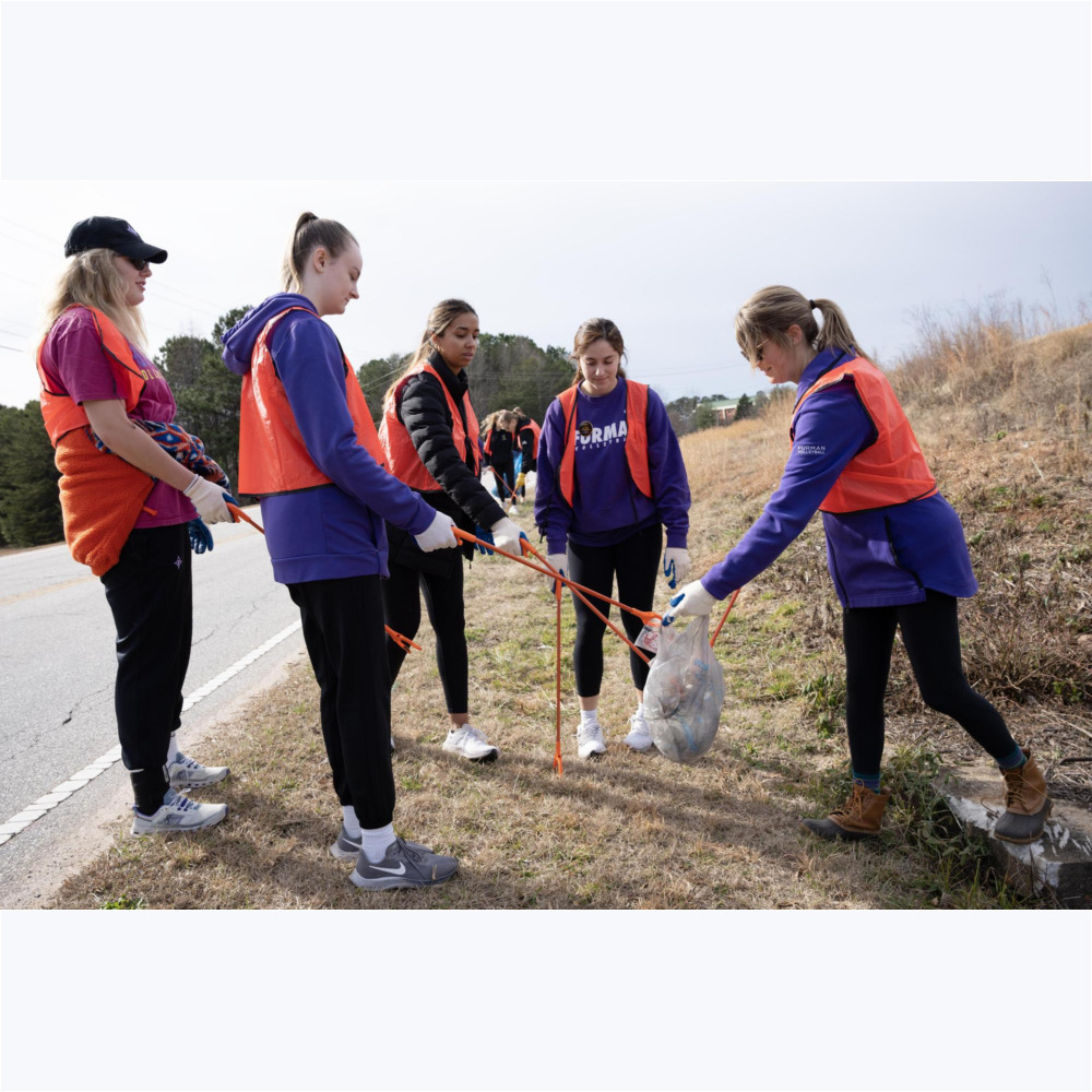 The Furman volleyball team picks up trash along Krieger Drive in Travelers Rest.