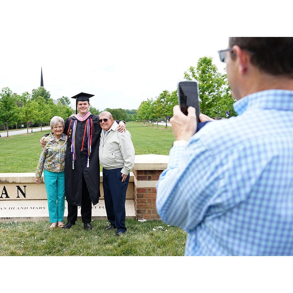 A student poses for a photo prior to the May 6 Commencement ceremony.