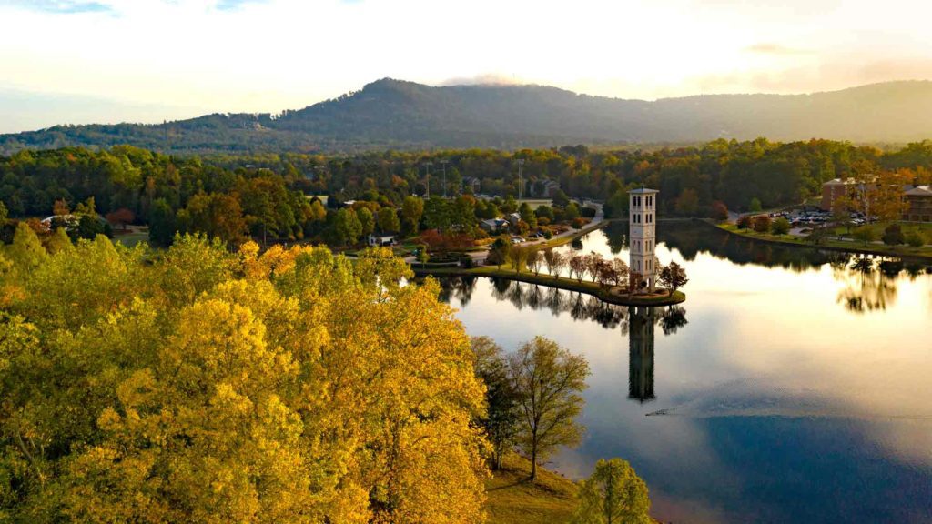 Aerial view of Fall furman campus over lake and bell tower