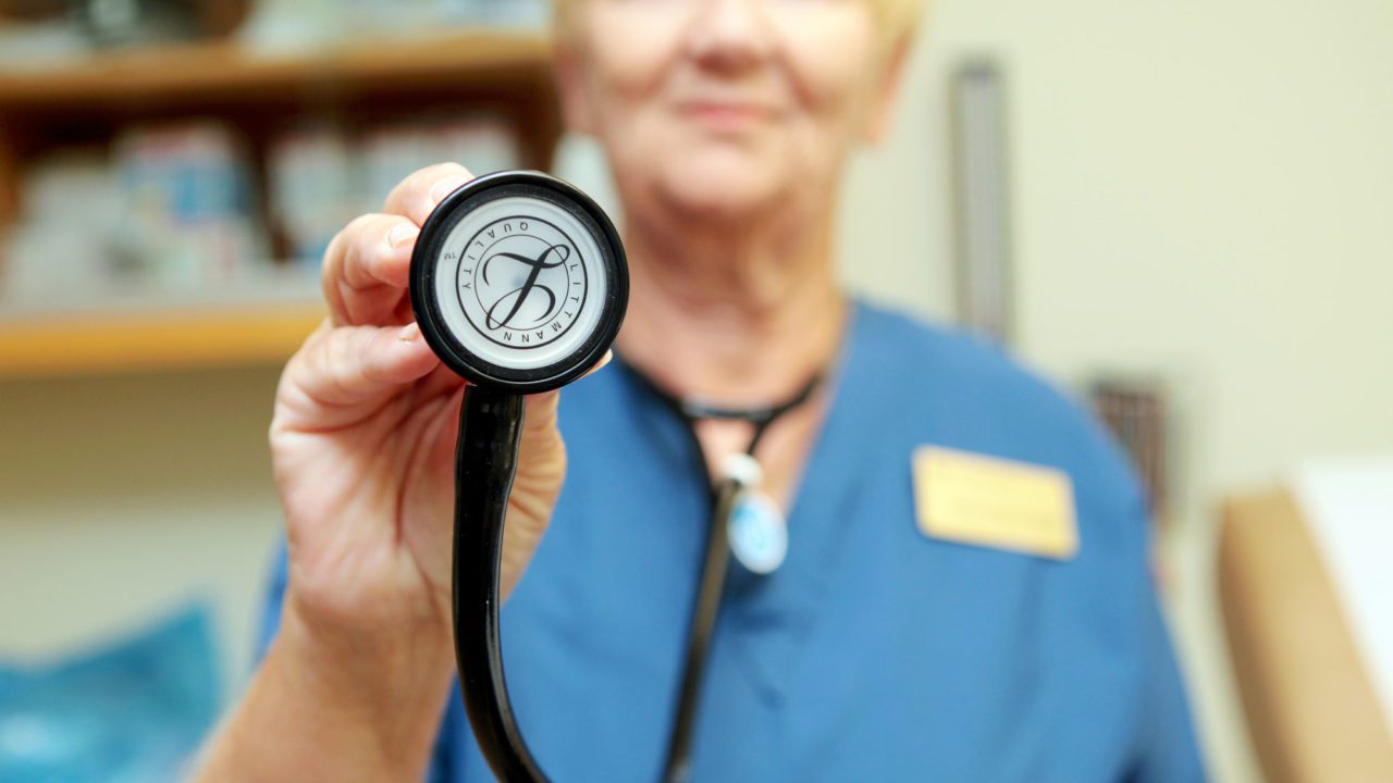 Nurse holding up a stethoscope