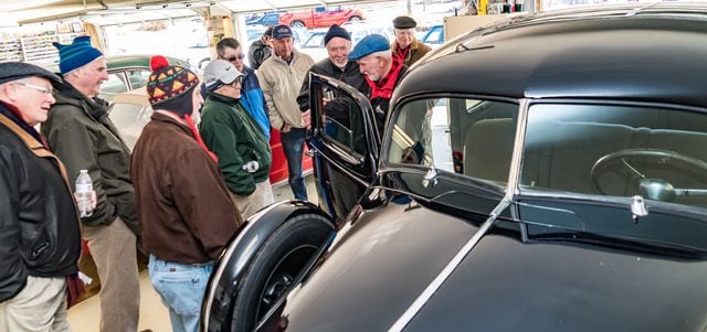 Classic car show, students looking at vehicle