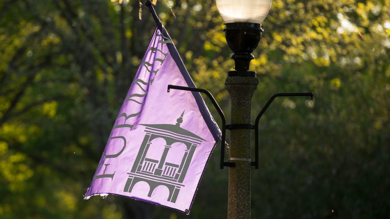 Furman flag in the breeze, while attached to a street light