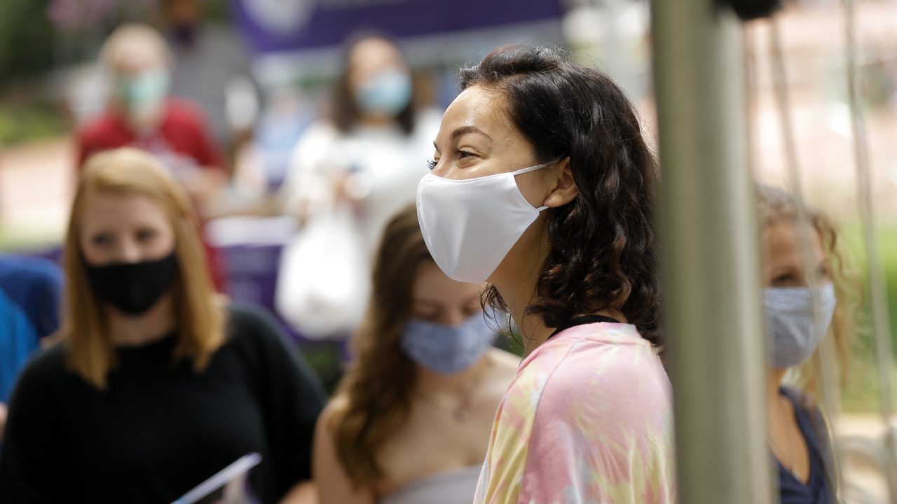 Girl wearing mask, smiling