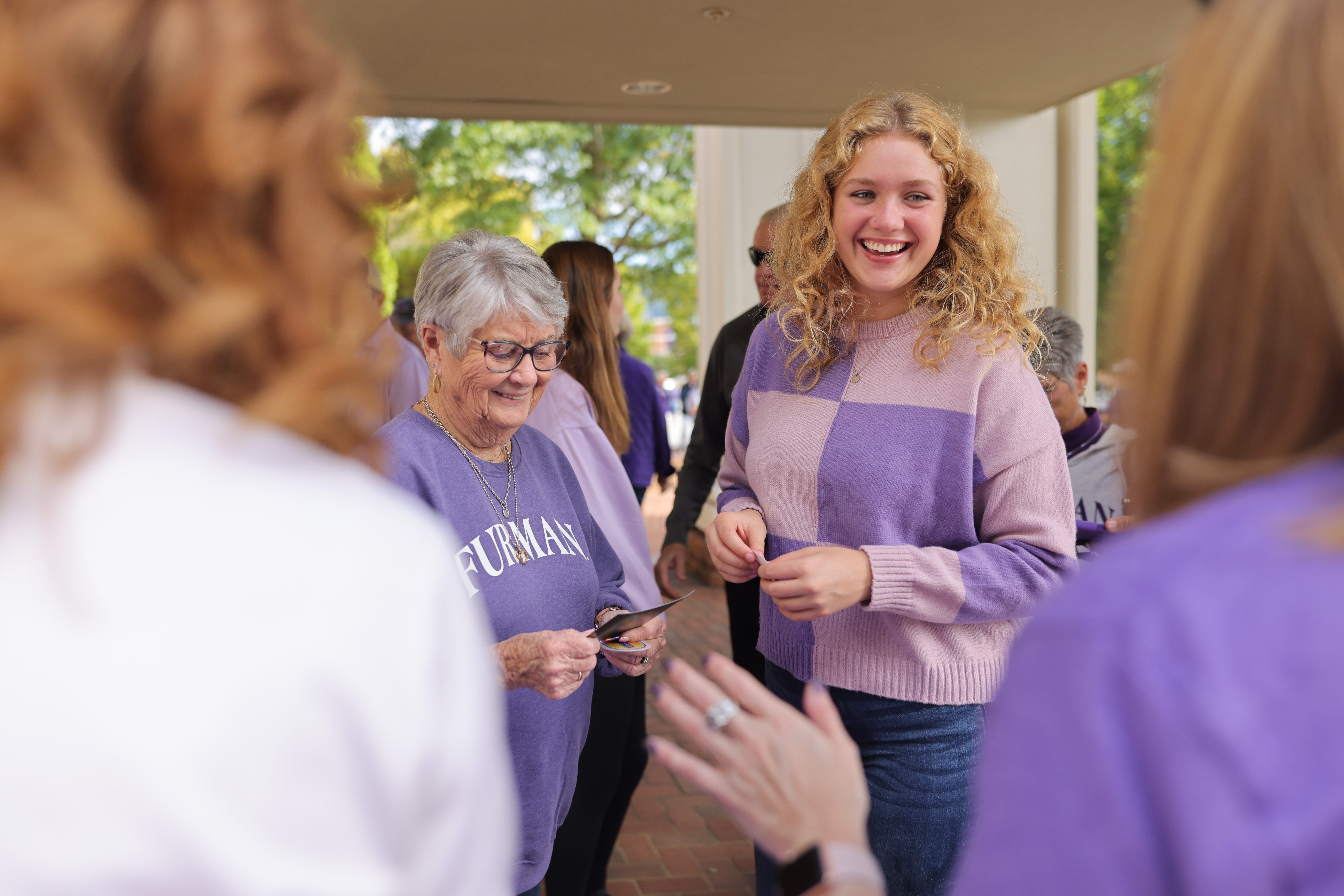 Young lady with older lady, both wearing purple