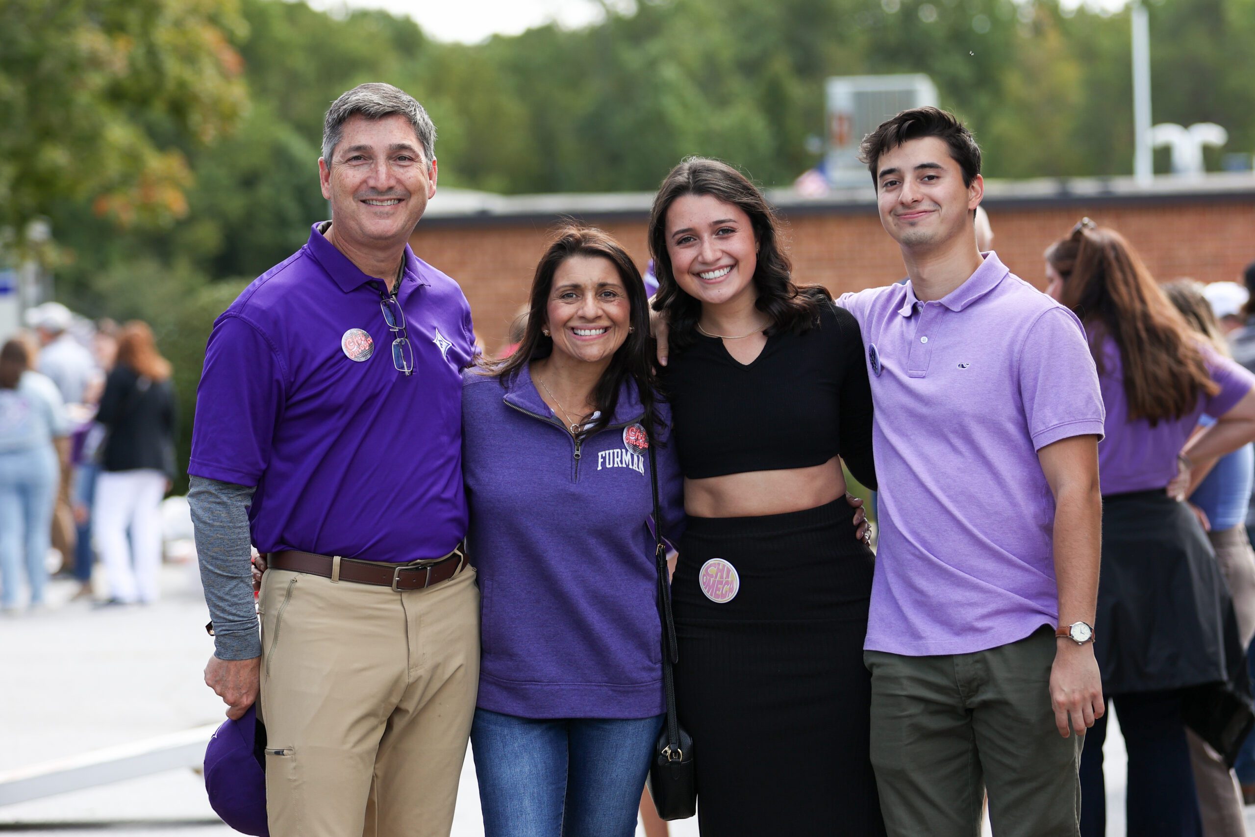 Family of 4 with 2 young people and their parents in Furman gear