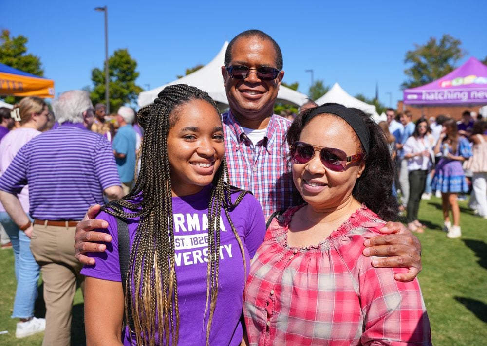 Student and her parents at a football tailgate