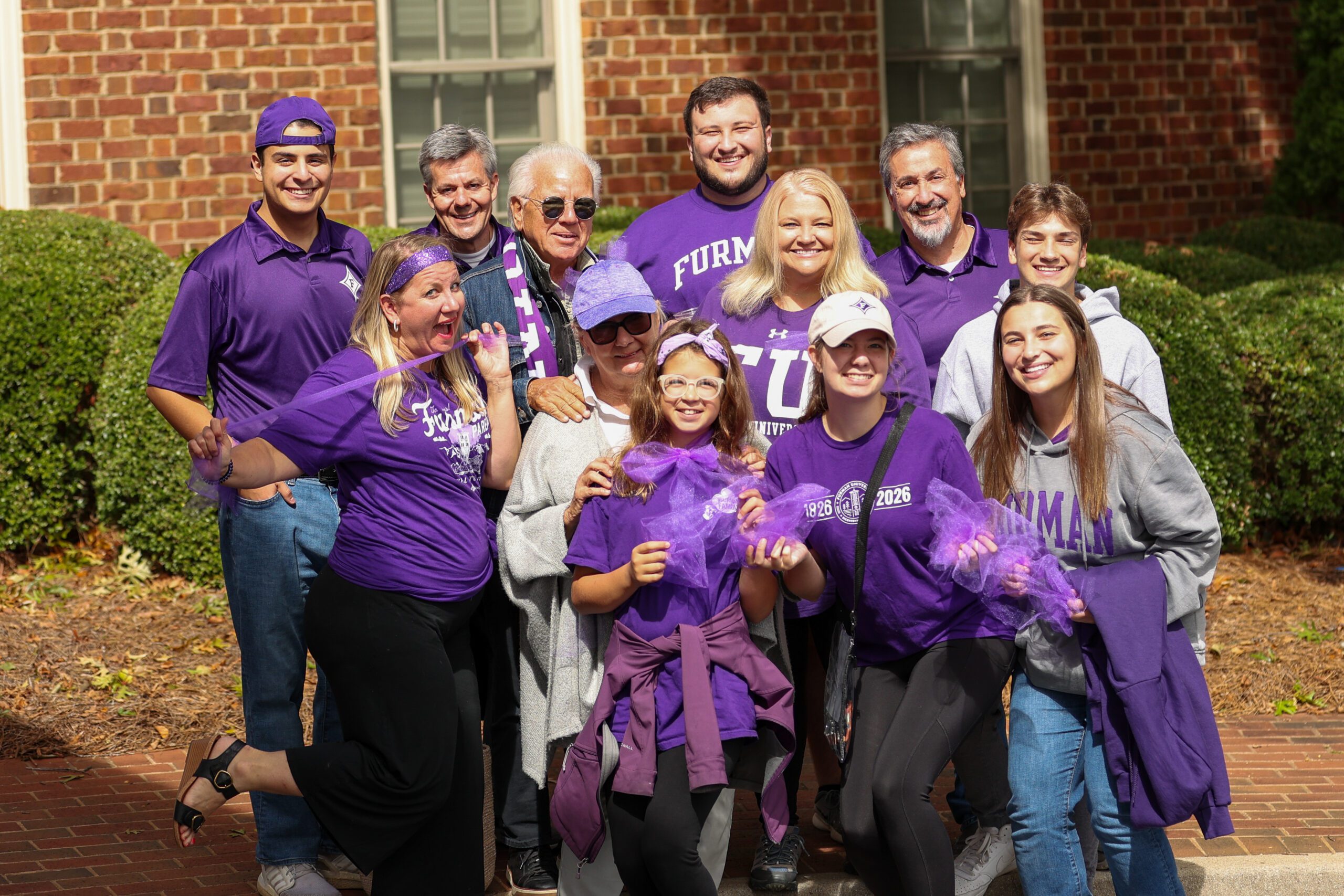 multi-generational family in Furman purple and wear