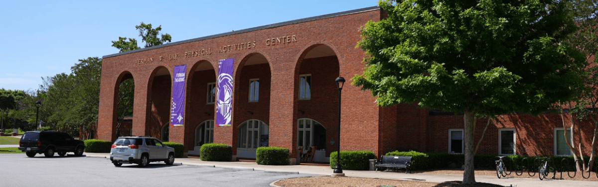 picture of the front of the Herman W. Lay Physical Activities Center as taken from the traffic circle on Furman University's campus.