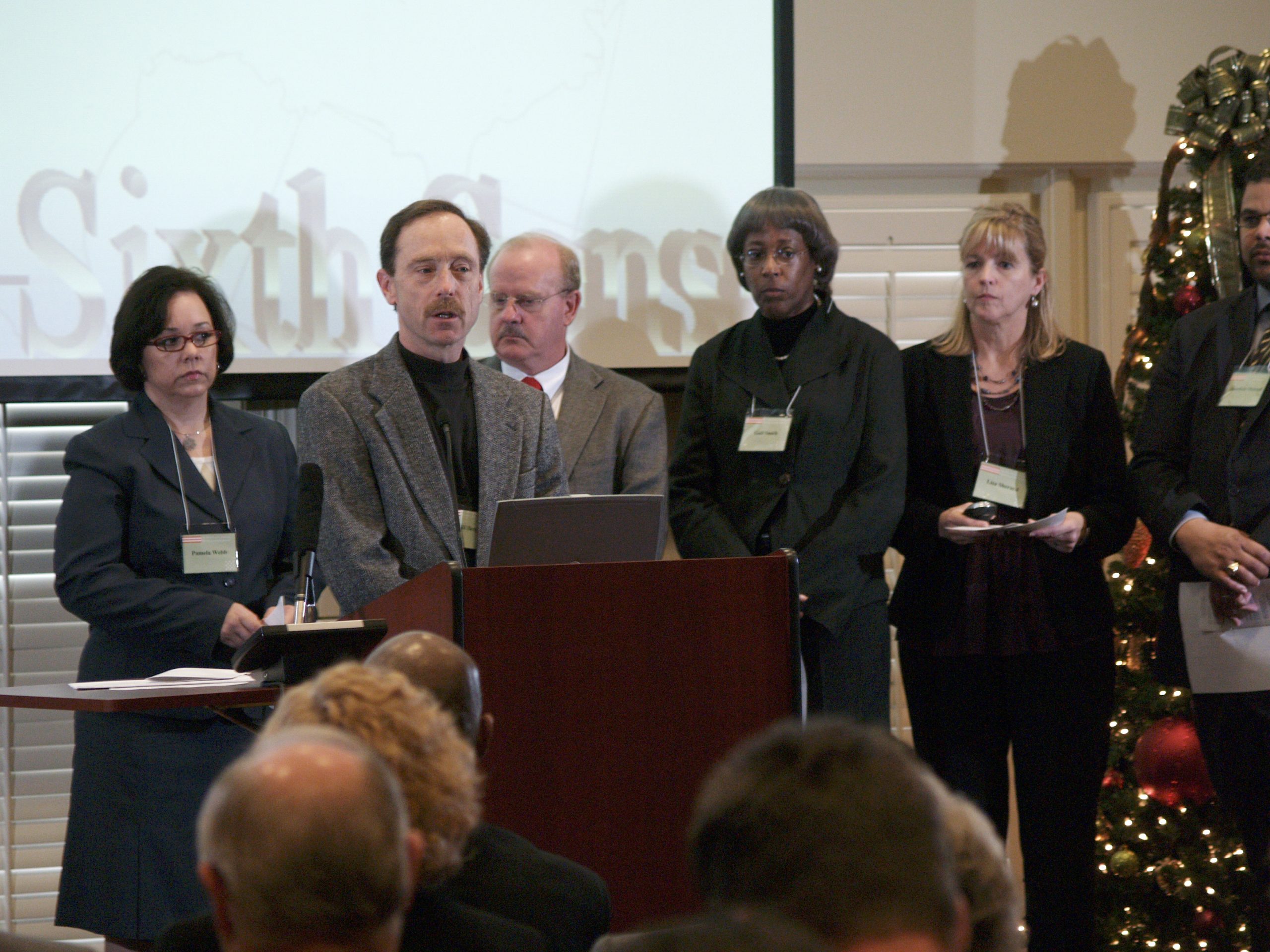 (l-r) Pamela Webb, Bill Berg presenting, Ted Hendry, Gail Smith, Lisa Sherard, and Jonathan Metcalf
