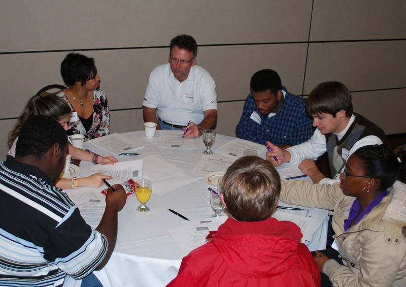 DLI participant Jim Dunbaugh working with a group of students