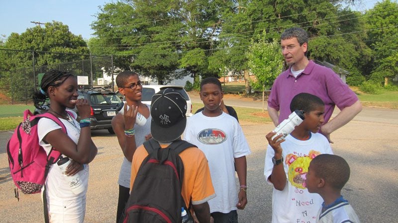 Rev. David Taylor, Building Dreams at Clemson University, giving instructions on bike safety and bike mechanics