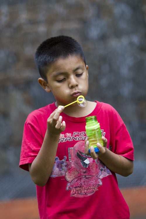 One of the children enjoying the bubbles from Mobi-Rec!