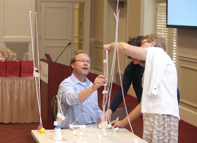 Tom Peters along with Aline Vernat and Barbara Martin, STEM in Motion, score the activity submissions.