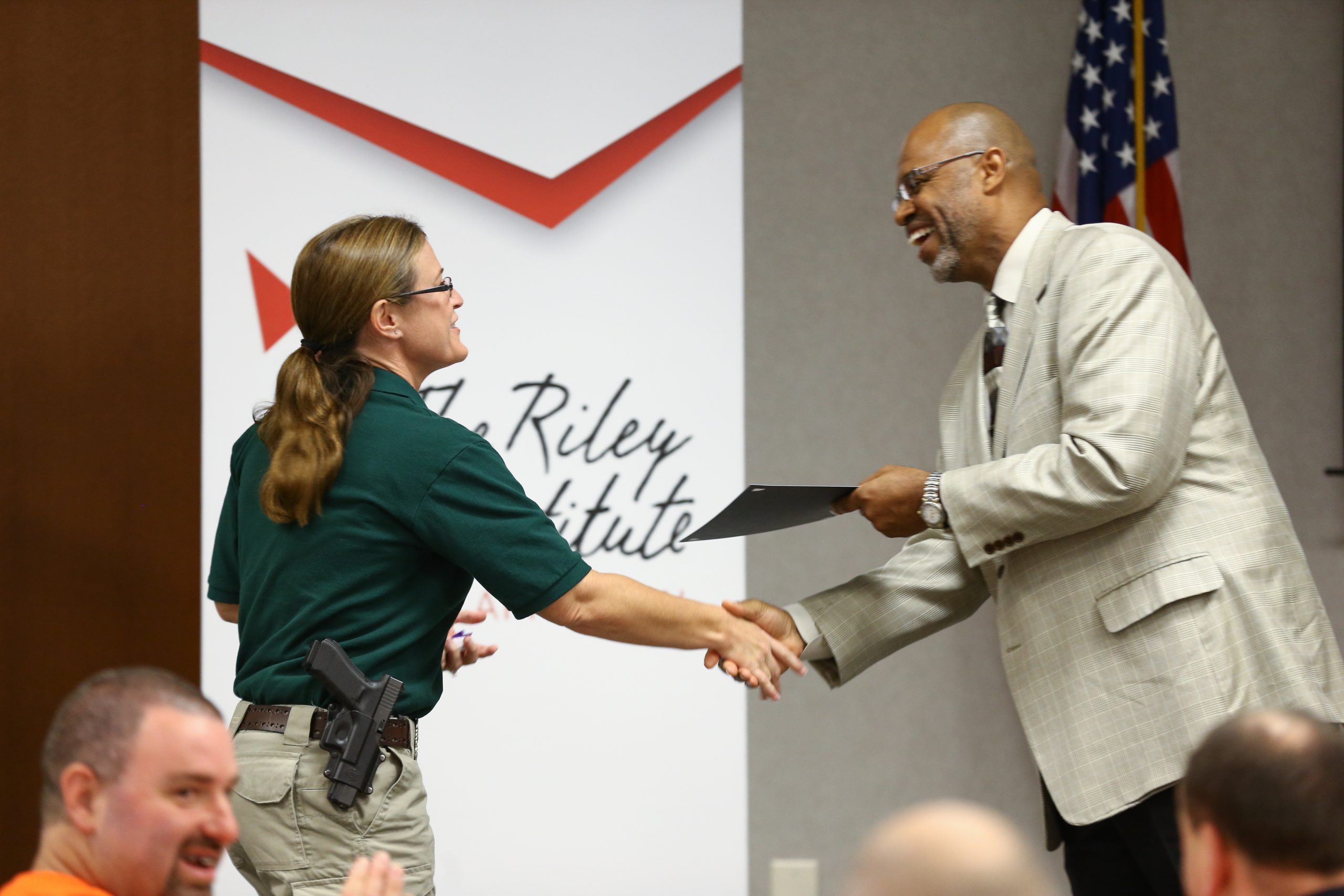Juan Johnson presenting the Riley Fellow certificate to Selena Small, Horry
