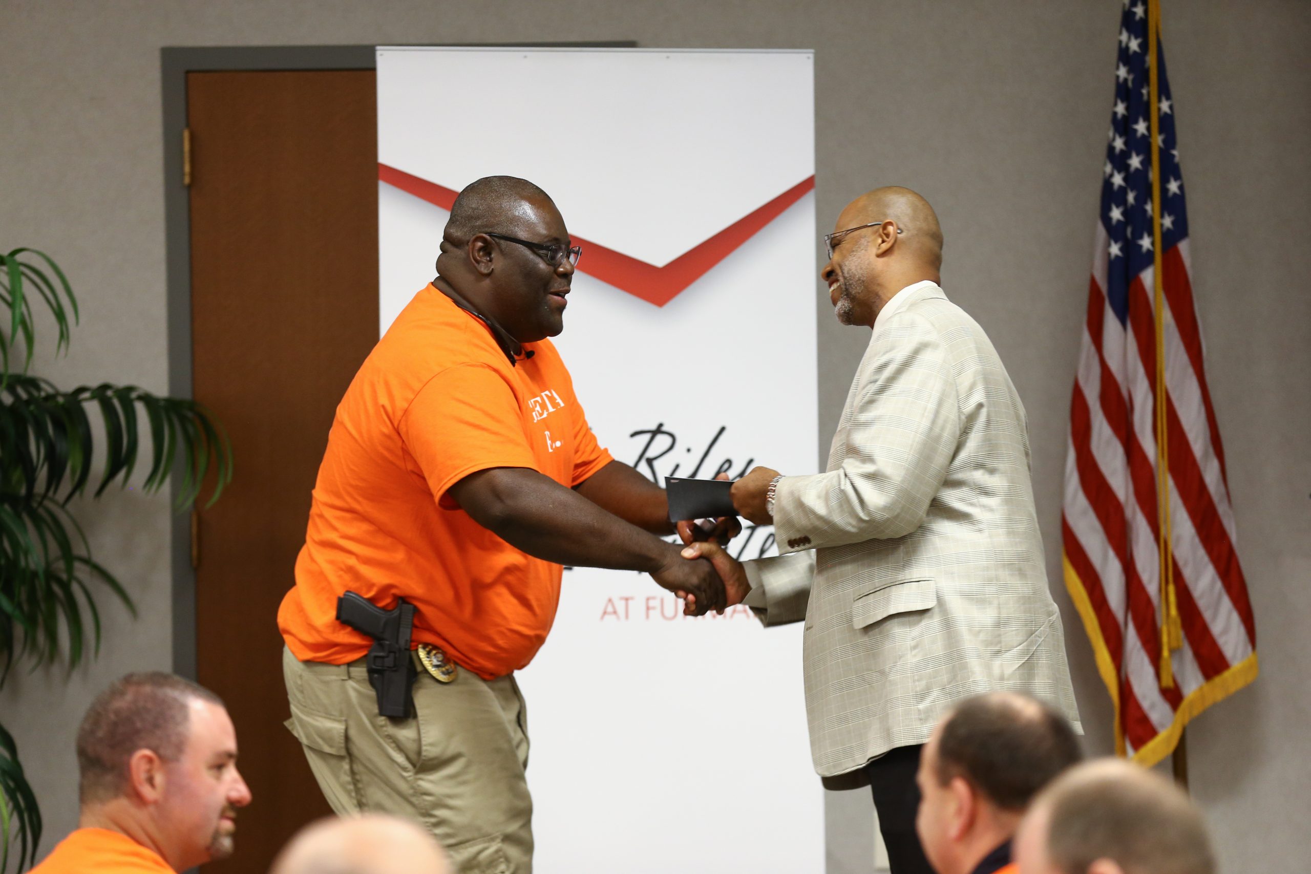 Juan Johnson presenting the Riley Fellow certificate to Timmie Williams, Greenville