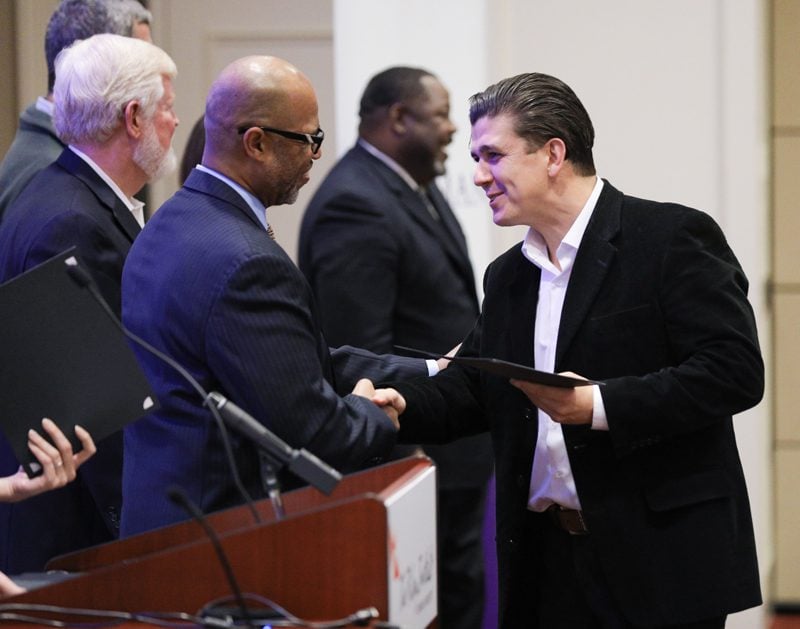 Akan Malici, Bridges to Success, receiving his Riley Fellow certificate from Juan Johnson